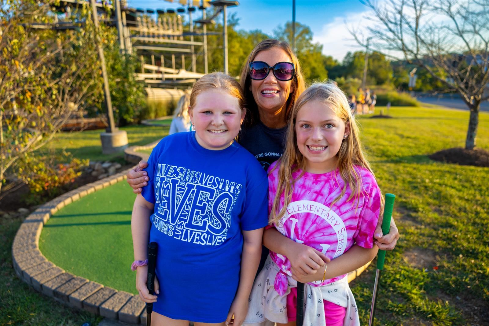 principal and two students at mini golf